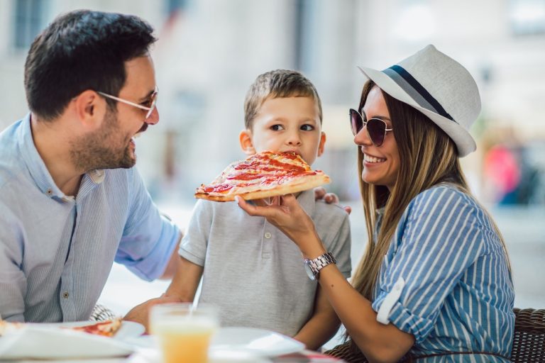 Happy family eating in a restaurant